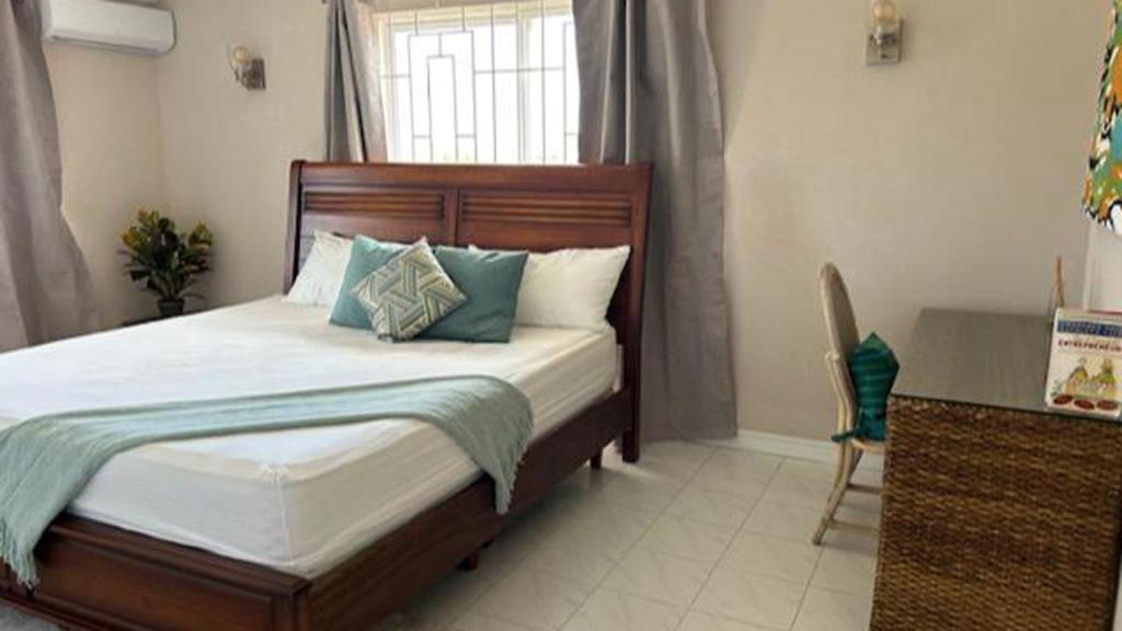 a bedroom with a bed and a window at Hope Winds - by ZenBreak in Christ Church