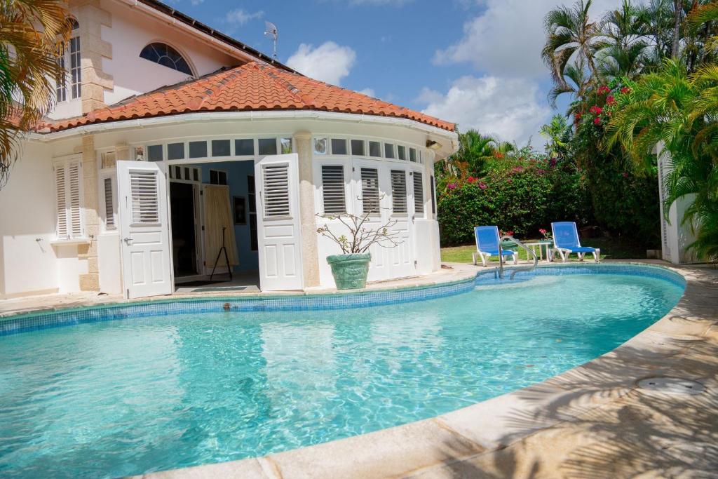 a swimming pool in front of a house at Marzalea - by ZenBreak in Saint James