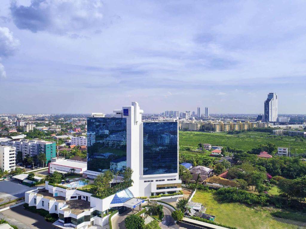 an aerial view of a tall building in a city at Novotel Bangkok Bangna in Bangna