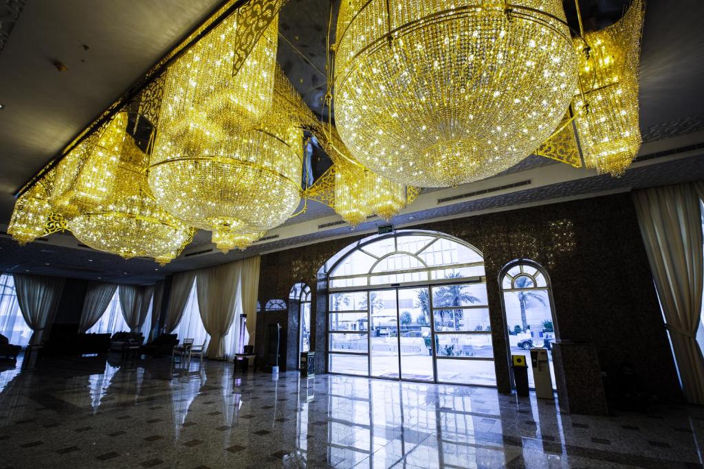 a lobby with many lights hanging from the ceiling at Sara Palace Apartments- family only in Kuwait