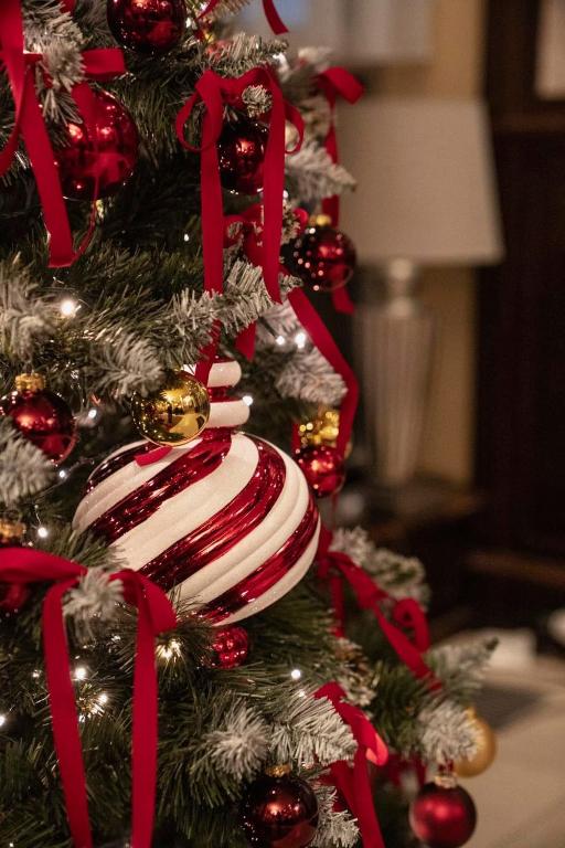 a christmas tree with red and white decorations at Apollo Hotel Bratislava in Bratislava