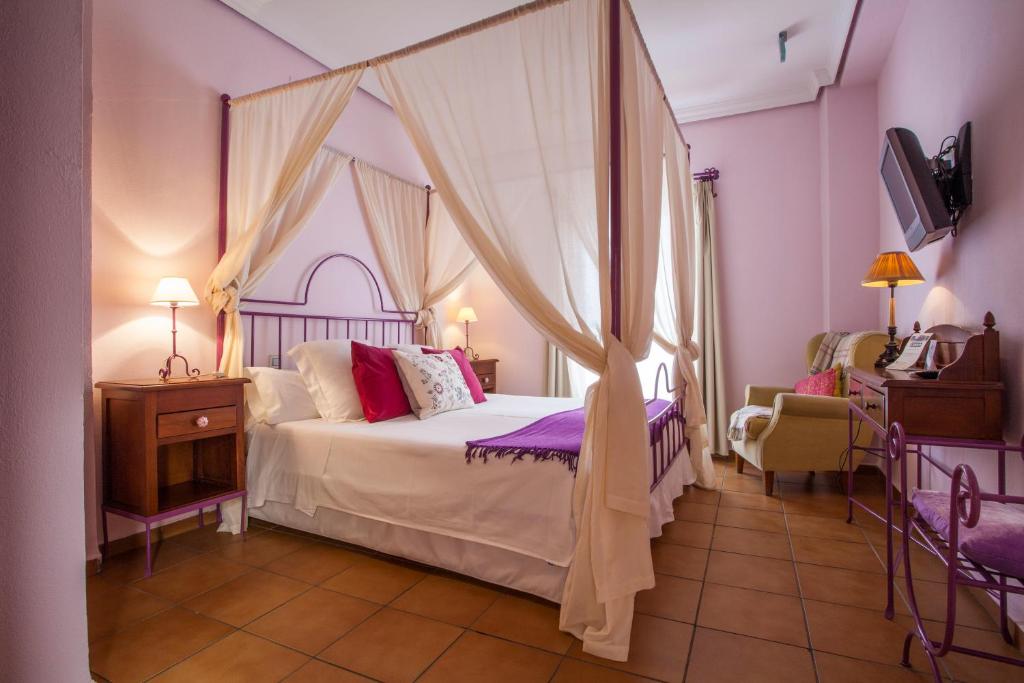 a bedroom with a bed with a canopy at La Casa del Maestro Boutique in Seville