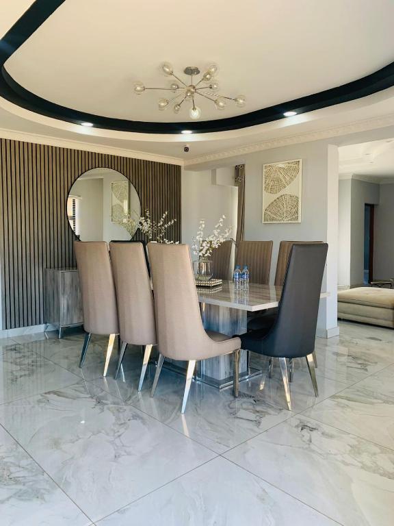 a dining room with a table and chairs at Khulanathi Guesthouse in Engcobo