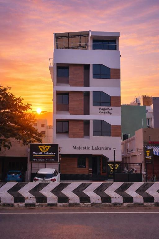 a building with a car parked in front of it at Majestic Lakeview Madurai in Madurai