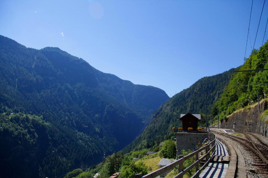 a view of a mountain with a train on the tracks at Lieu Secret dans les Alpes Suisses in Le Trétien