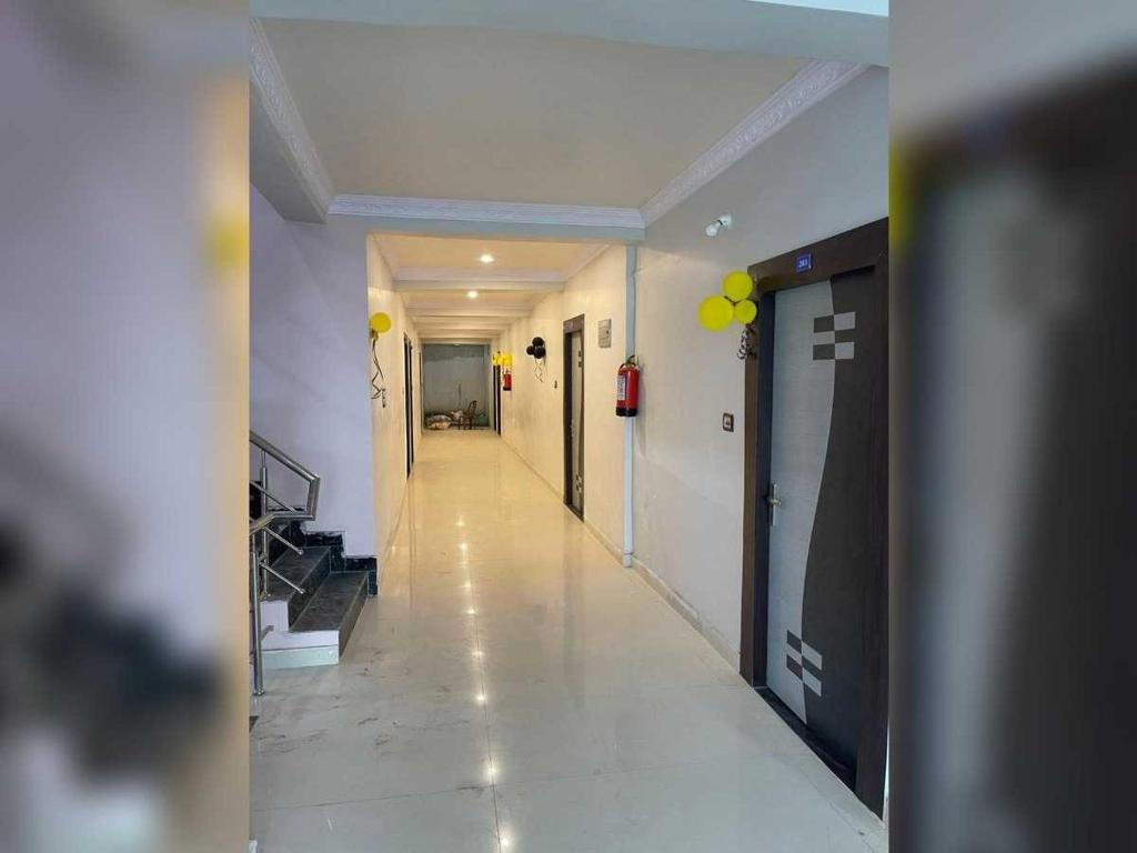 a hallway of a building with yellow balloons on the walls at Hotel O Downtown Rooms & Banquet in Darbhanga