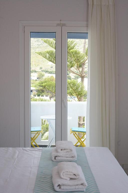 a bedroom with a bed and a window with a view at Irene Studios in Agios Petros