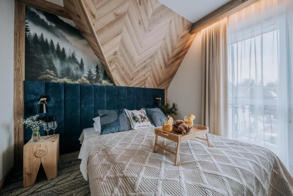 a bedroom with a large bed and a large window at Pokoje Gościnne u Moniki Zakopane in Zakopane