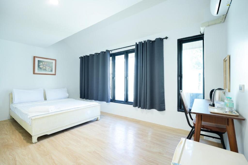 Ένα ή περισσότερα κρεβάτια σε δωμάτιο στο XX Snap Sukhumvit 1 -BTS Nana Bangkok