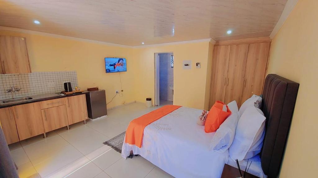 a large bedroom with a bed and a kitchen at kiddy in Mogwase