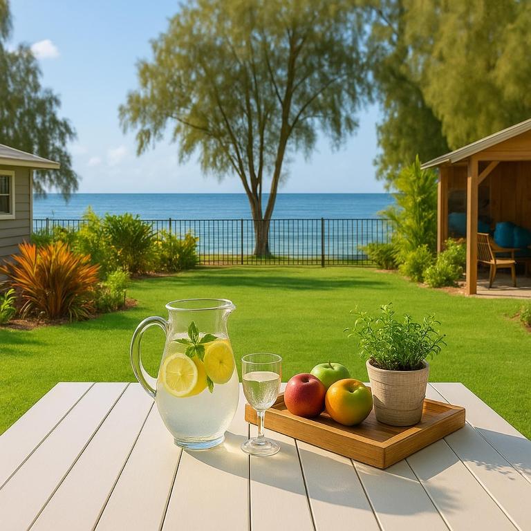 a wooden table with a tray of fruit and wine glasses at Berkeley Waterfront - Family & Pet Paradise in Berkeley Vale