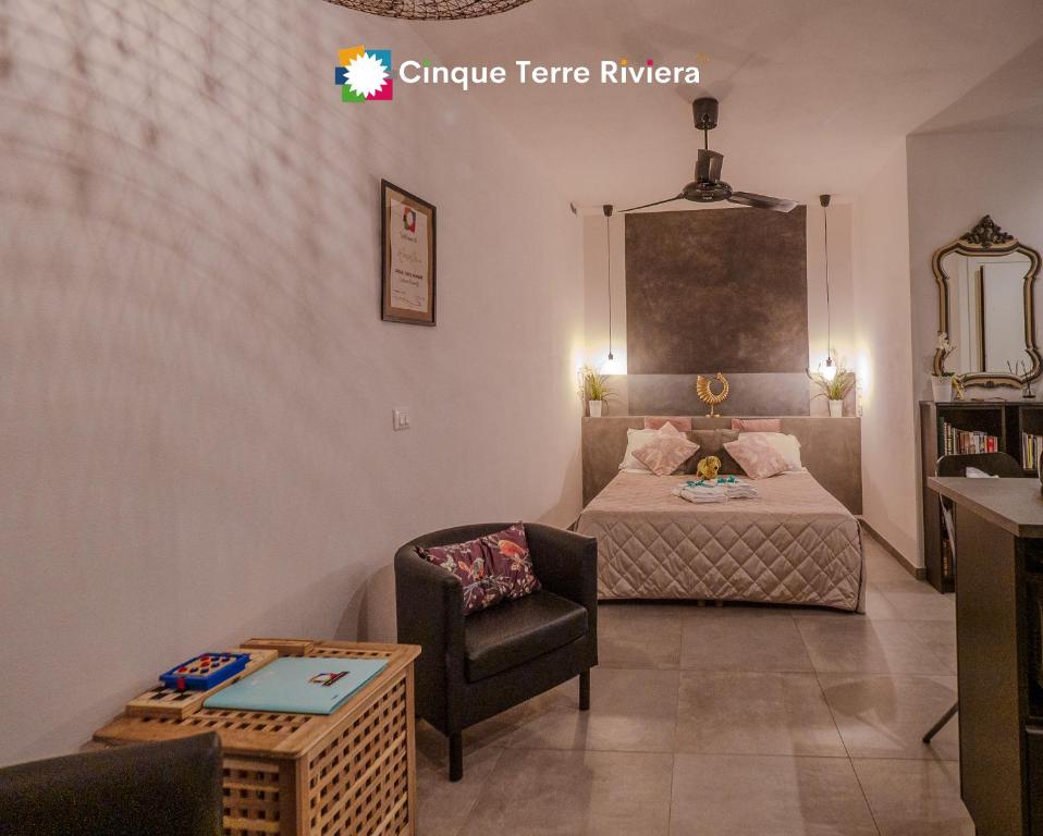 een kleine slaapkamer met een bed en een stoel bij Camaella Luxury Studio in Vernazza