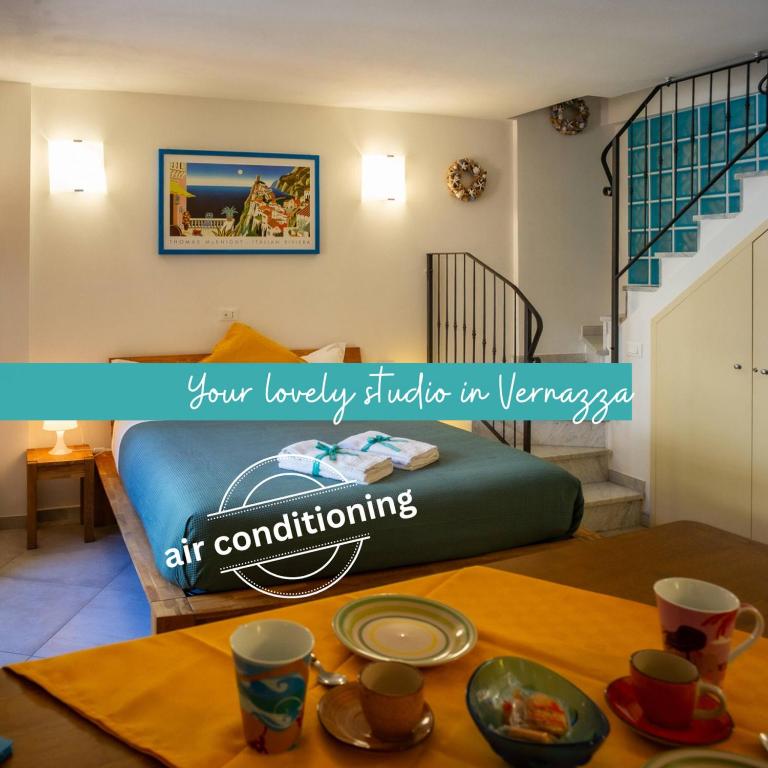 a bedroom with a bed and a table with dishes on it at Ventu de Ma Studios & Rooms in Vernazza