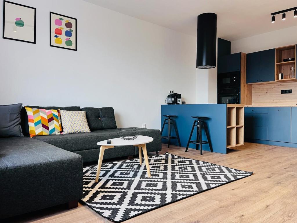a living room with a couch and a table at Jan Gustav Apartments in Liptovský Mikuláš