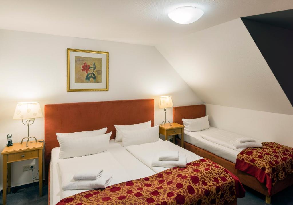 Postel nebo postele na pokoji v ubytování Apparthotel Bad Schandau by STEIGER Hotels