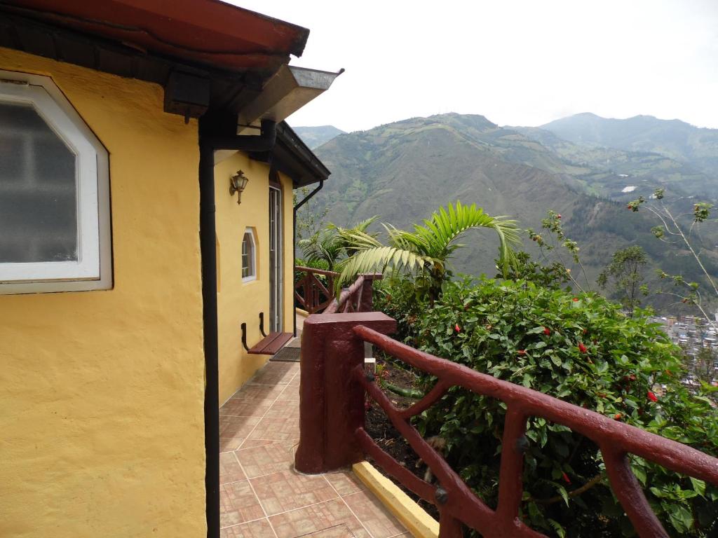 un balcone di una casa con montagne sullo sfondo di La Casa Amarilla a Baños