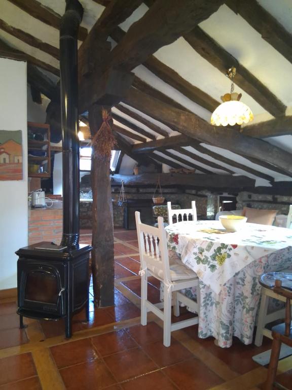 a kitchen with a table and a wood stove at R2R - Ático con encanto Colindres - C08B01 in Colindres
