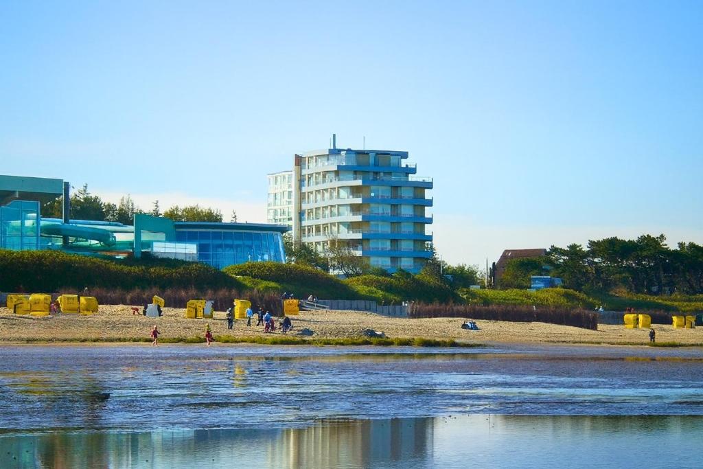 a beach with a tall building in the background at Seehütte 004 in Cuxhaven