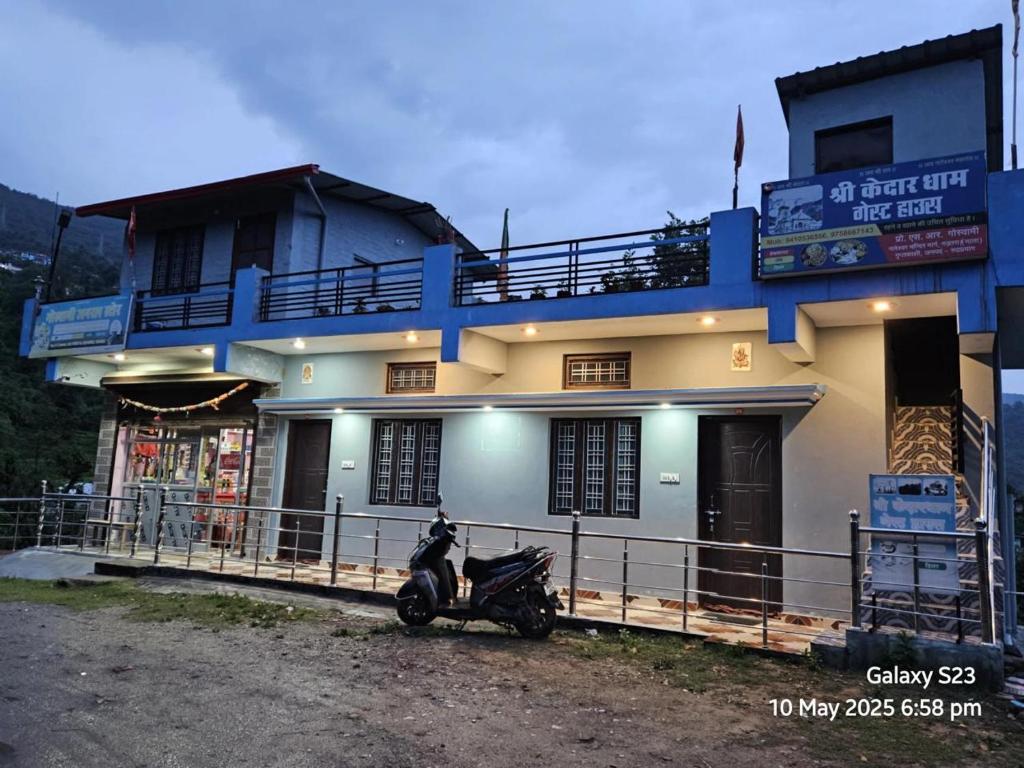 a motorcycle parked in front of a building at Shree Kedar dham Guest House in Gupta Kāshi