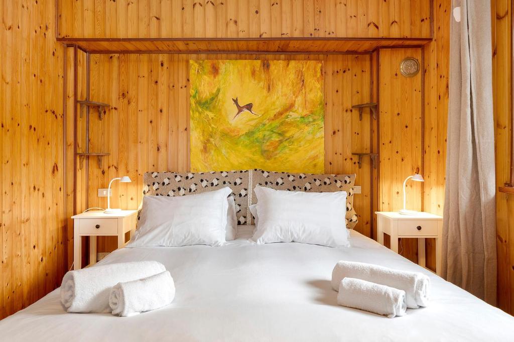 a bedroom with a large bed with two night stands at La Maisonnette in Valtournenche