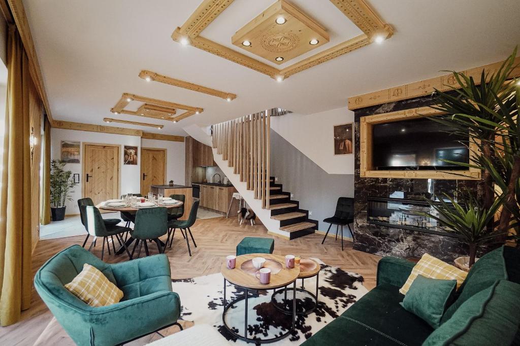 a living room with a couch and a fireplace at Krzeptówki House in Zakopane