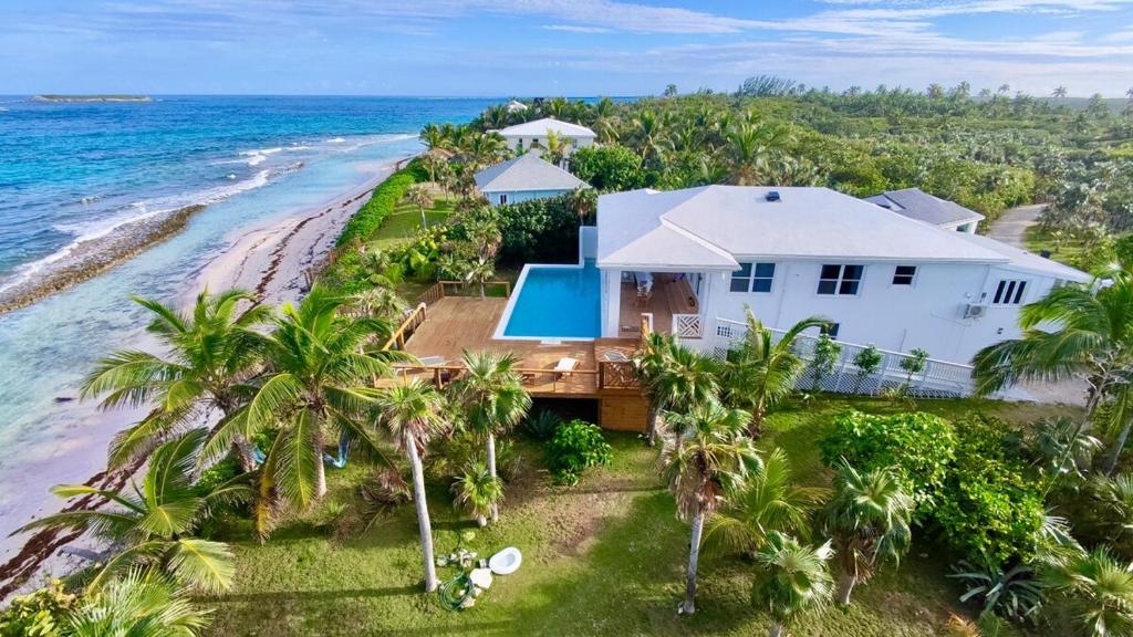 an aerial view of a house on the beach at 8 Bedroom Ocean Front in Eleuthera Double Bay with pool in Savannah Sound
