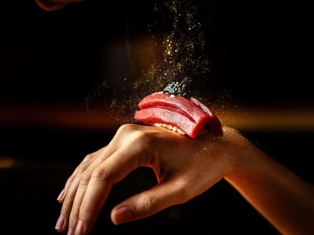 a person holding an ice cream in their hand at VIE Hotel Bangkok - MGallery Collection in Bangkok