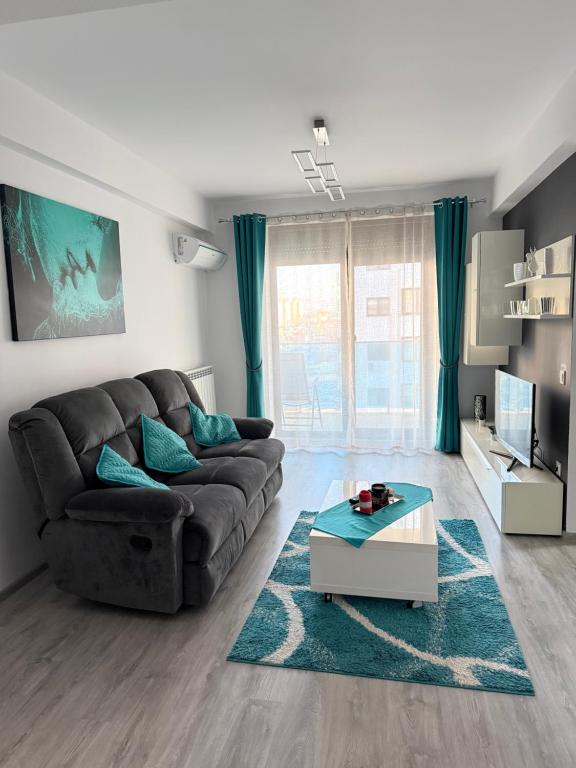 a living room with a couch and a coffee table at Modern Stay in Şelimbăr