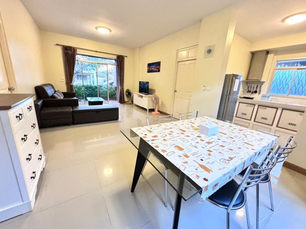 a kitchen and living room with a table and chairs at Happy House Casa Seaside Rayong in Ban Chak Phai