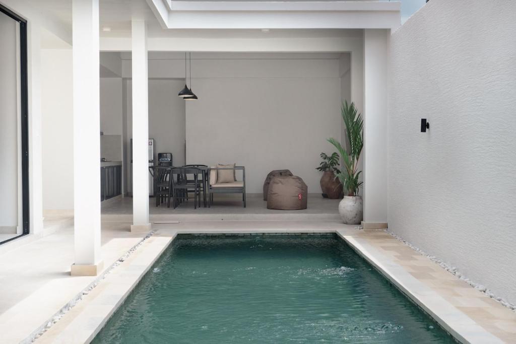 a swimming pool in the middle of a house at Villa IKIN in Lovina