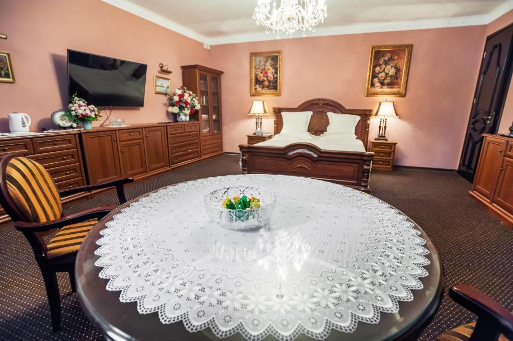 a living room with a table and a bed at Saban Deluxe in Lviv