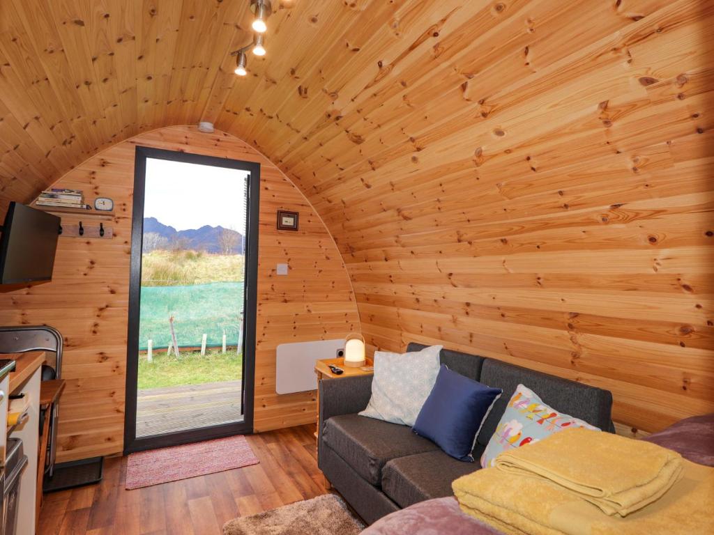 a living room with a couch and a window at The Pod at Greenbank in Kilbride