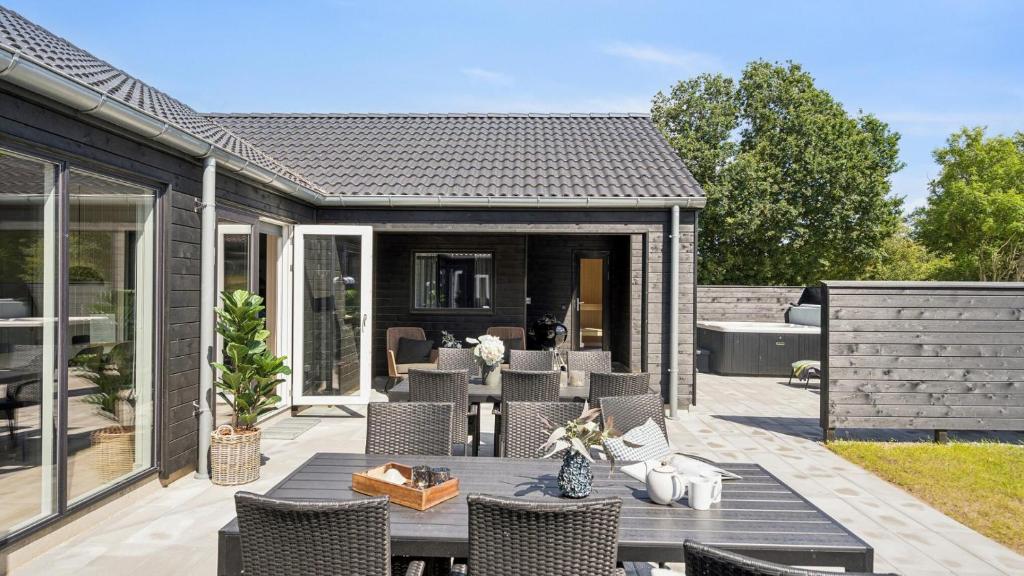a backyard patio with a table and chairs at Villavilla #657 - Mommark, Sydjylland in Sarup