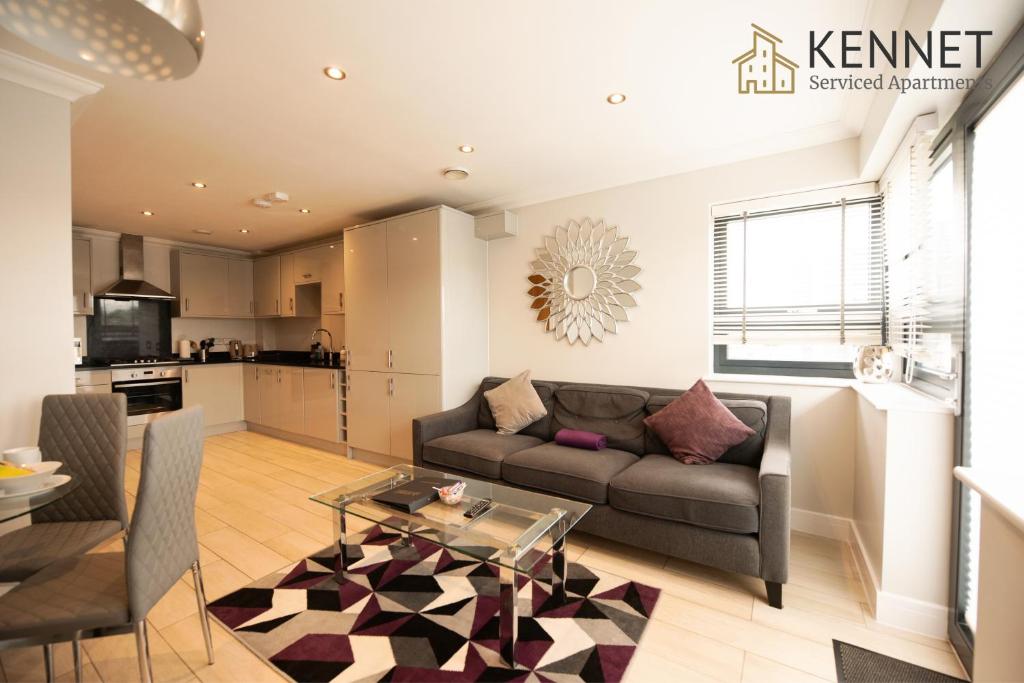 a living room with a couch and a table at Malthouse Court in Reading