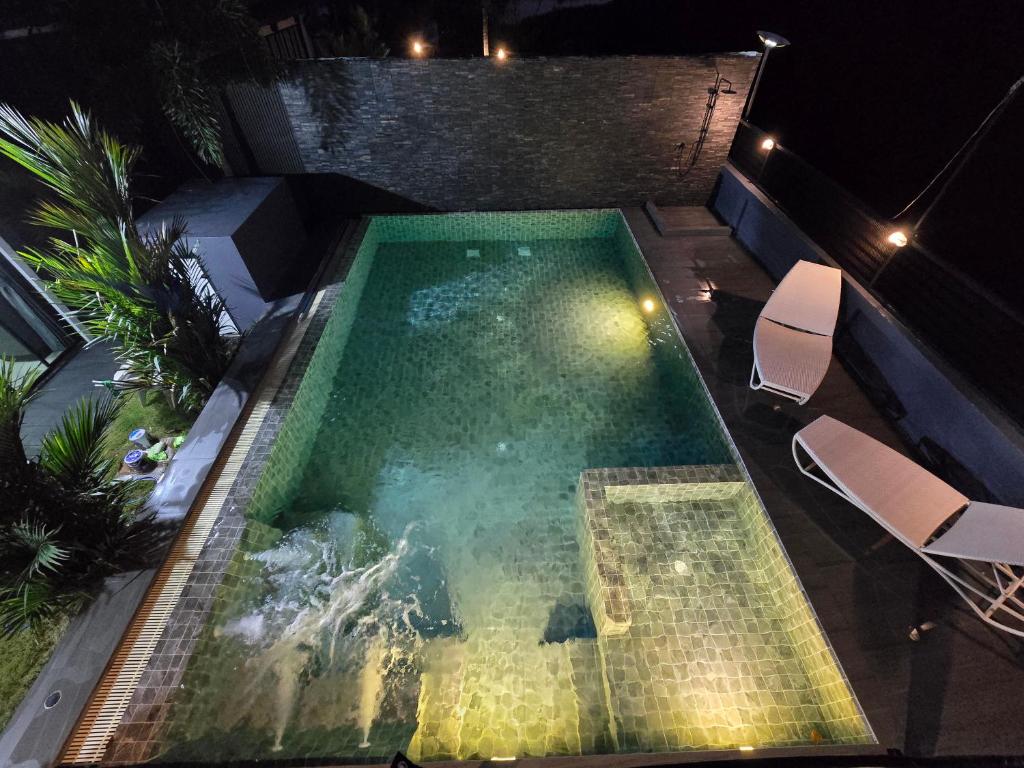 an overhead view of a swimming pool at night at Kathu V pool villa 171 in Kathu