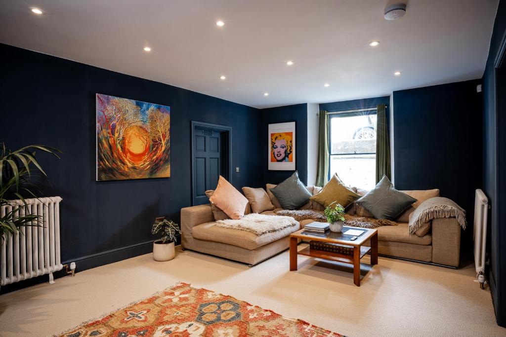 a living room with a couch and a table at BATH Luxury Georgian Flat in Bath