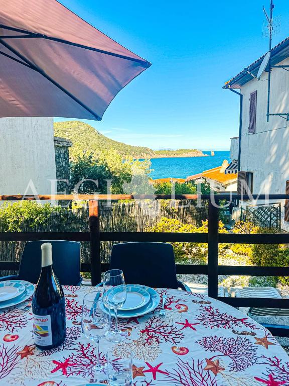 a table with a bottle of wine sitting on top at Carla 1 in Campese