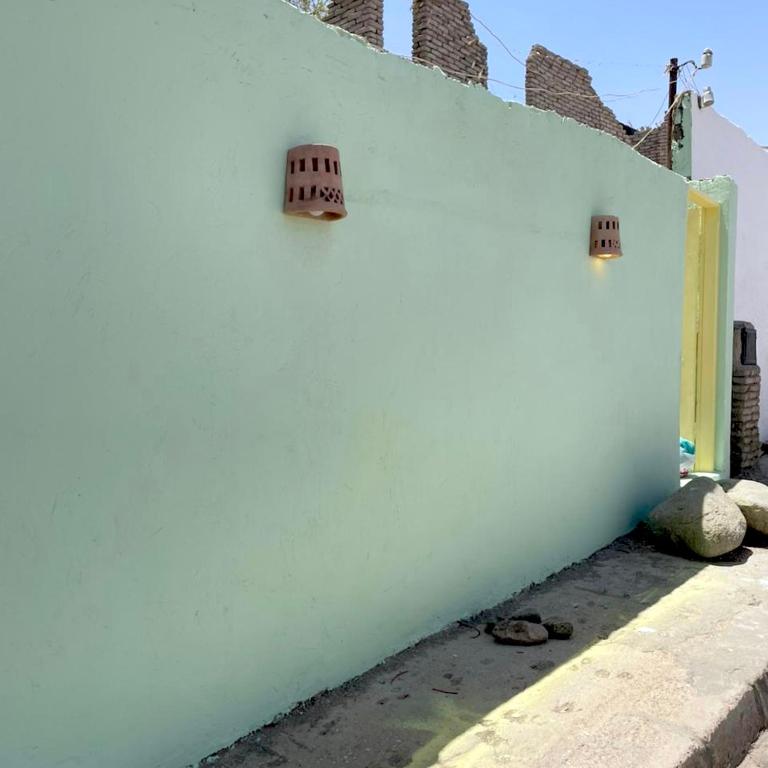 a white wall with two lights on the side of it at Amir House cozy studio in Dahab
