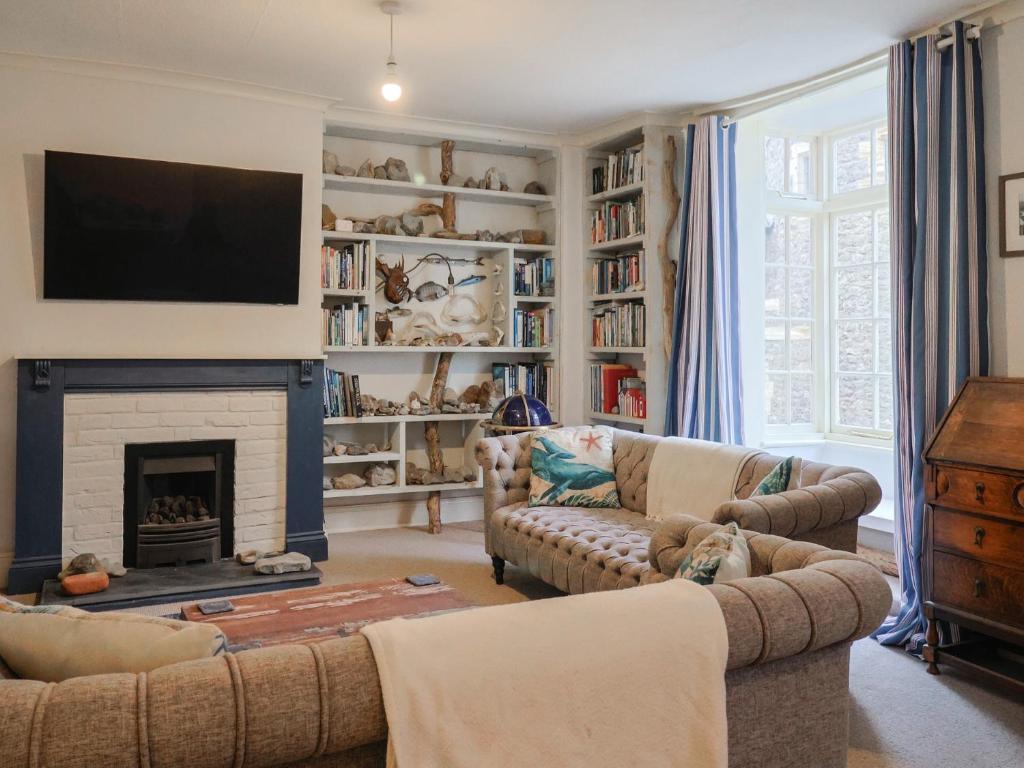 a living room with two couches and a fireplace at 5B Bridge Street in Lyme Regis
