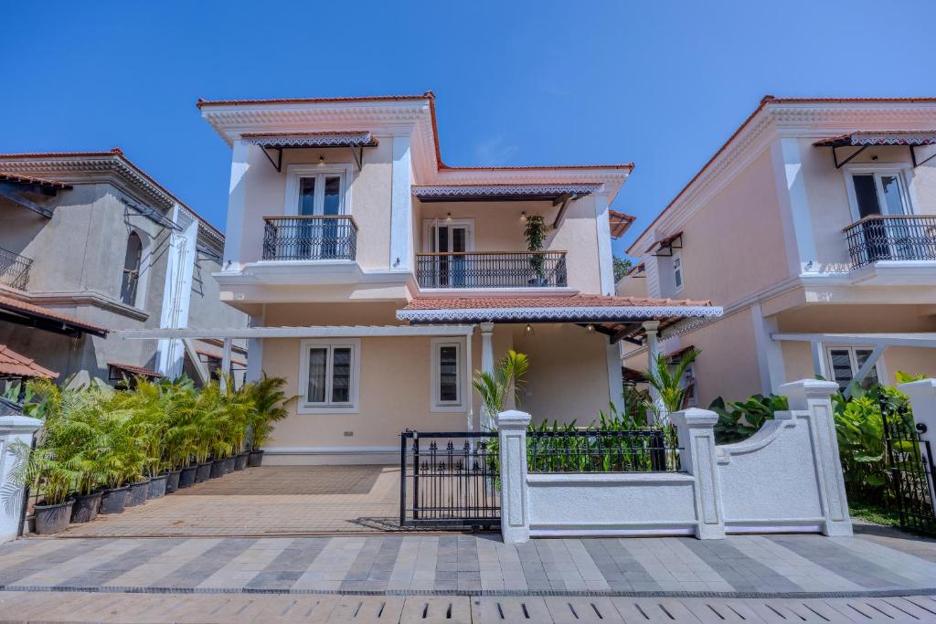 a house with a gate in front of it at ELIVAAS Signature Cygnus with Pvt pool in Mapusa