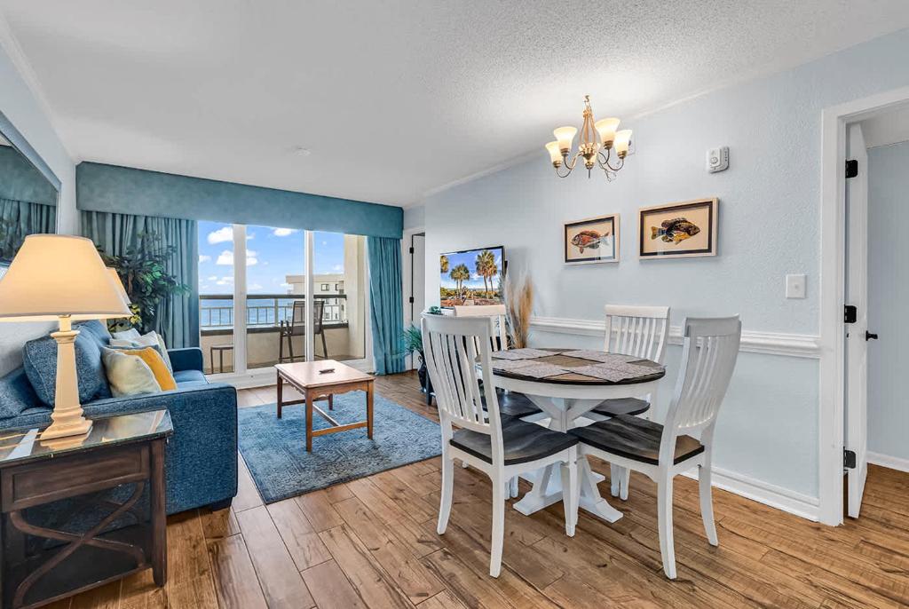 a dining room and living room with a table and chairs at Oceanfront Luxury 2BR Litchfield Beach Escape in Pawleys Island