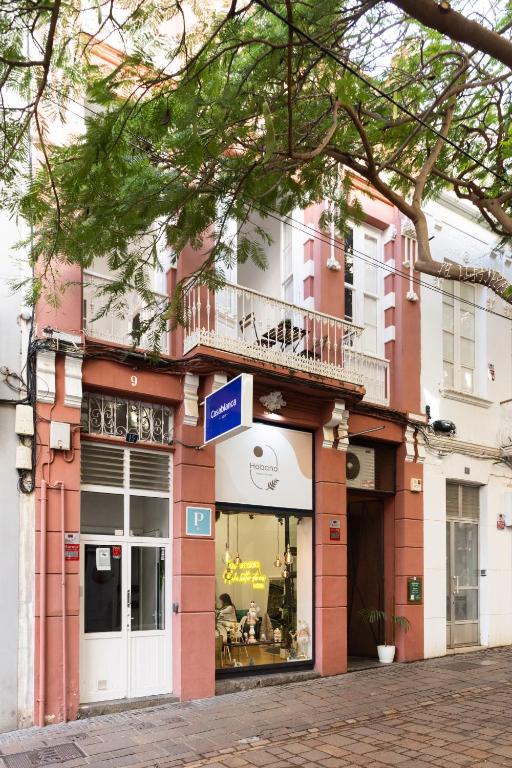 a store front of a pink and white building at Home2Book Pensión Casablanca in Santa Cruz de Tenerife