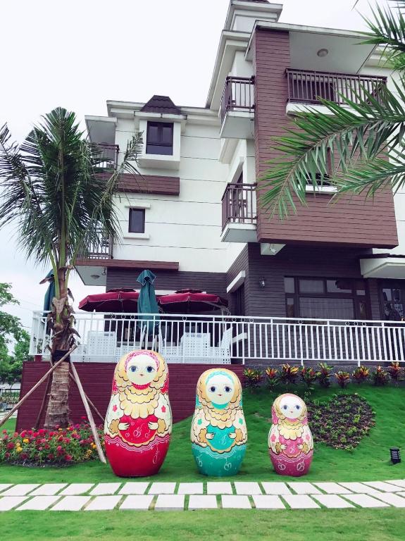 three colorful vases sitting in front of a house at Sophia B&amp;B in Dongshan