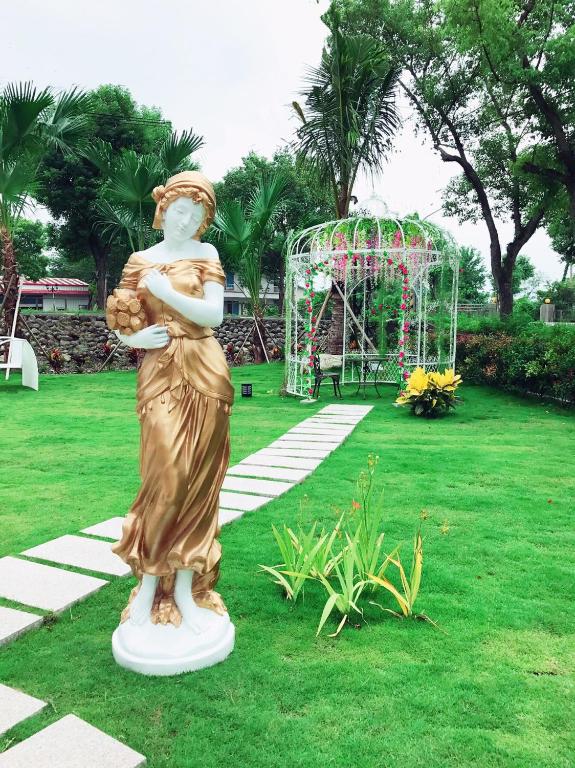 a statue of a woman standing in a park with a playground at Sophia B&amp;B in Dongshan