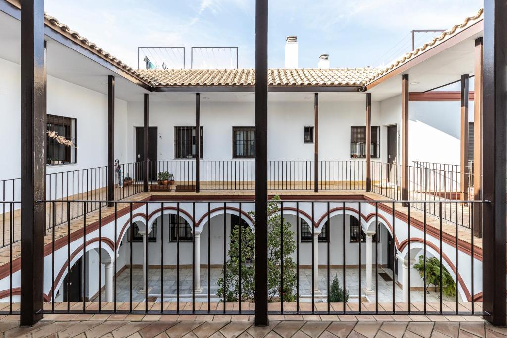 a view of the courtyard of a building with a fence at Doctor Fleming in Carmona