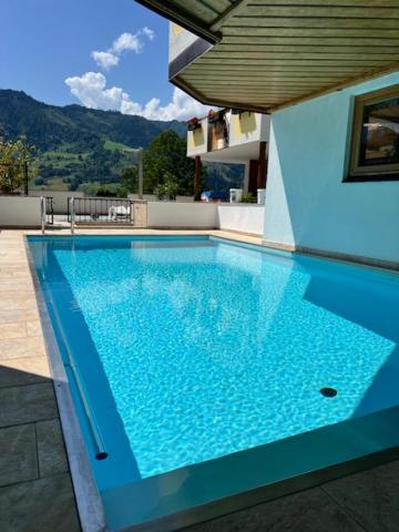 a large blue swimming pool on top of a building at Sonnhang Apartment Unterkofler in Sankt Johann im Pongau