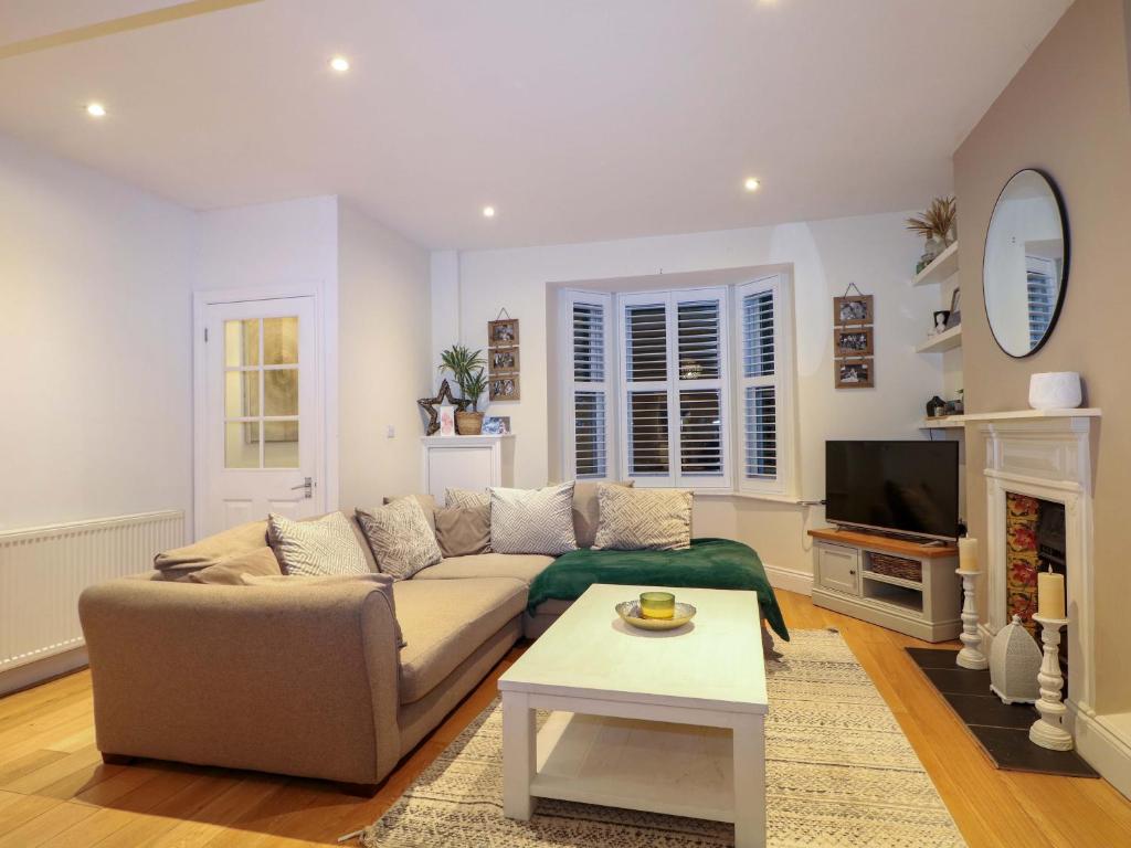 a living room with a couch and a tv at Gordon Avenue in Camberley