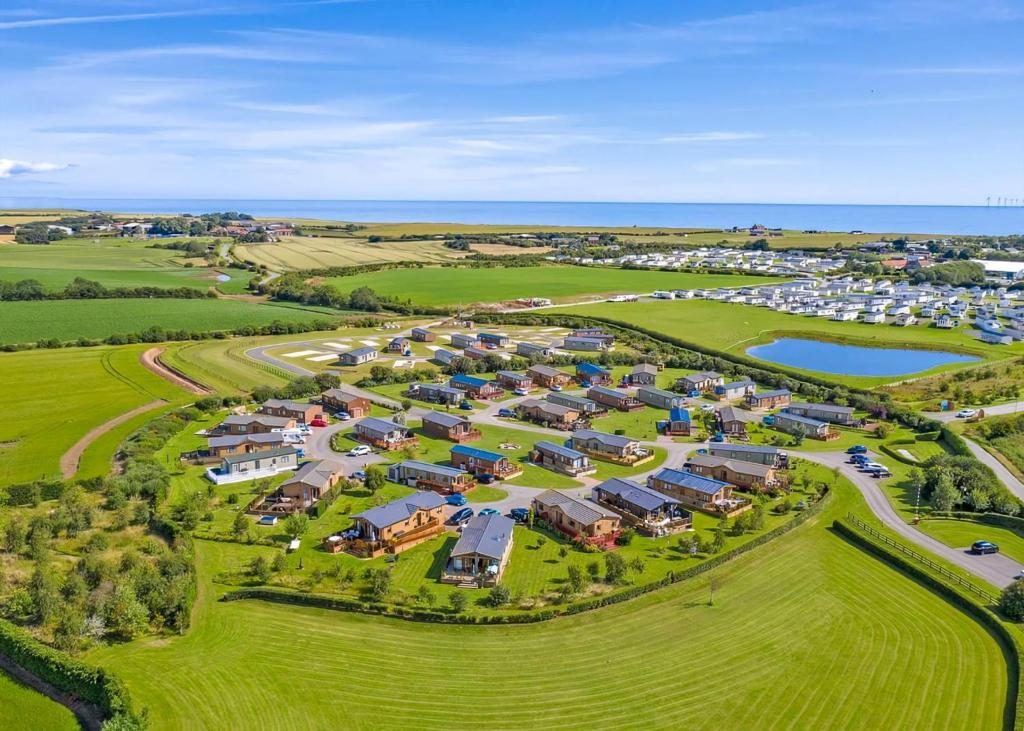 an aerial view of a park with houses and a lake at Holderness Country Park in Tunstall