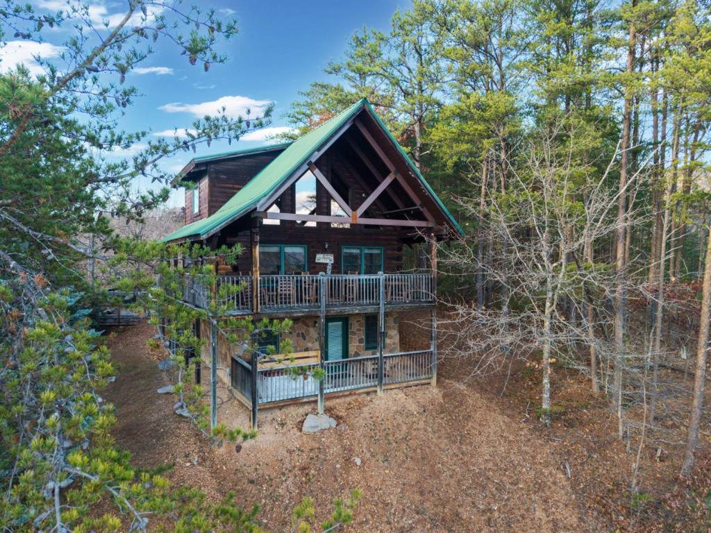 a cabin in the woods with a wrap around deck at High Cotton Epic Views Hot Tub Pool Table in Sevierville