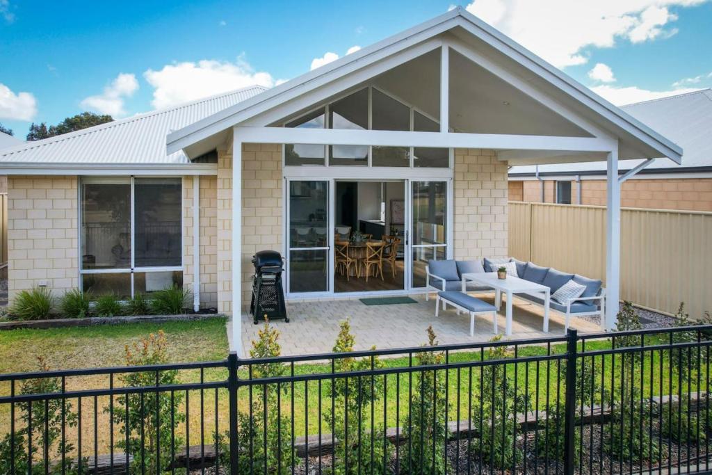 a house with a patio and a fence at Isla Escape Pet Friendly Dunsborough in Dunsborough